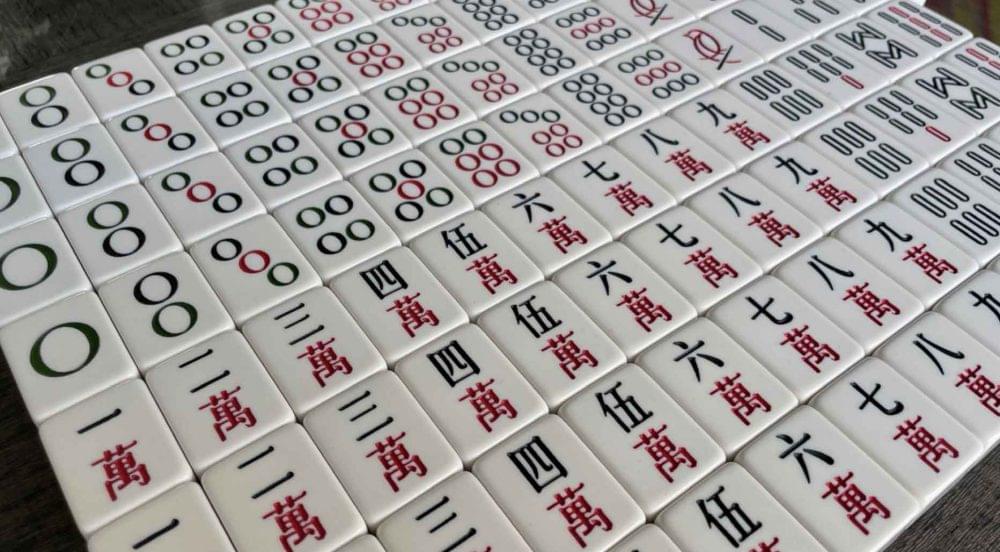 An overhead look at a complete set of mahjong tiles.